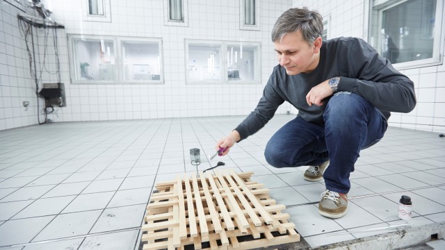 Robert Rett sets a wooden pallet on fire in the Bosch fire lab in Munich.
